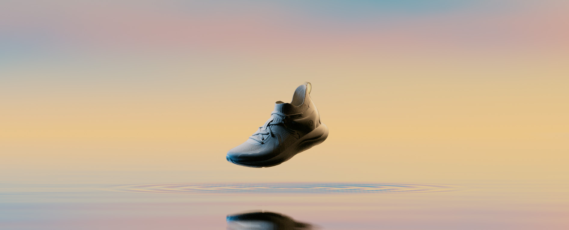 Shoe over water at sunset